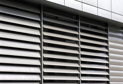 A close-up of a building with numerous metal shutters