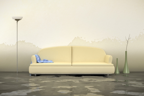 A couch and lamp in a flooded room