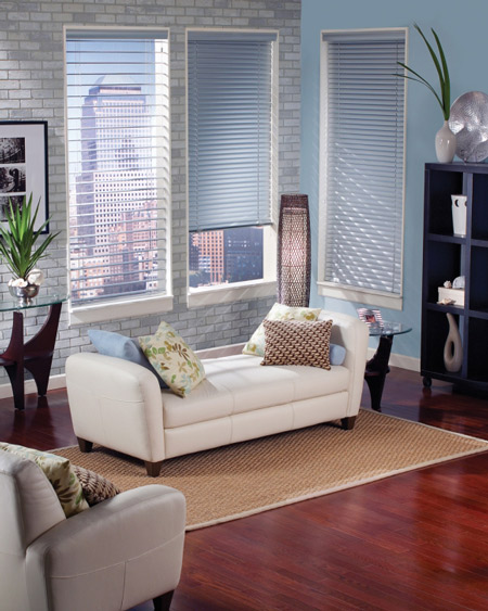 a living room filled with furniture and a window covered in blinds