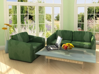A green living room with a table and chairs
